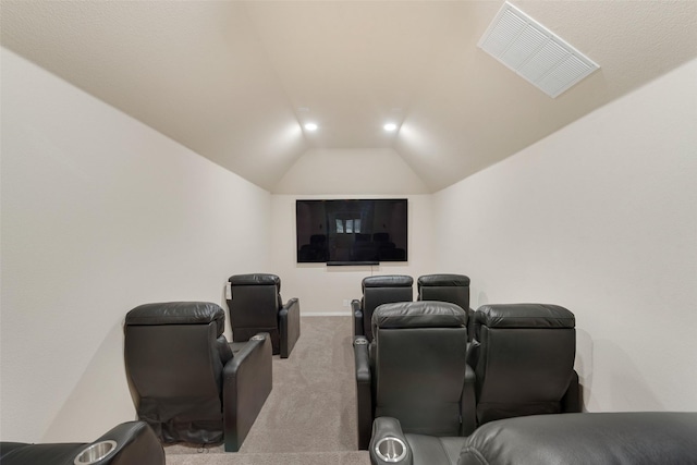 home theater room featuring light colored carpet and lofted ceiling