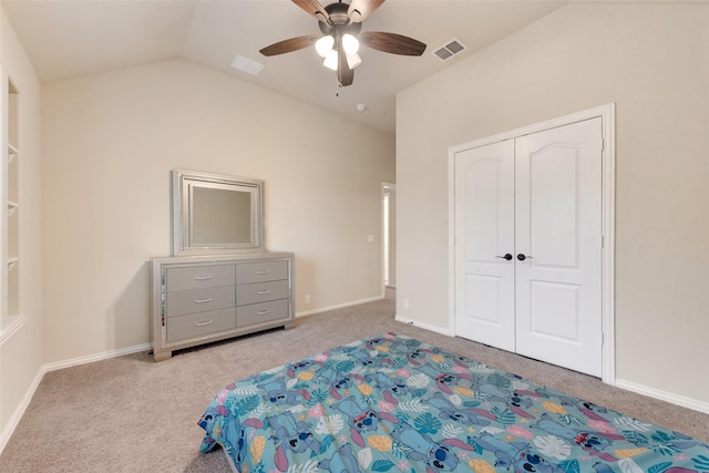 unfurnished bedroom featuring light carpet, a closet, vaulted ceiling, and ceiling fan