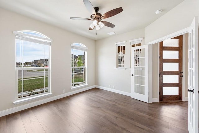 unfurnished room featuring ceiling fan, french doors, and dark hardwood / wood-style floors