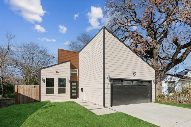 view of front of property with a front lawn and a garage