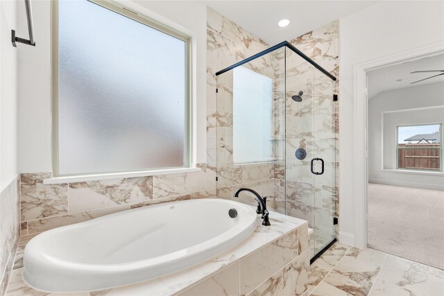 bathroom featuring tile patterned floors, tiled tub, and vanity