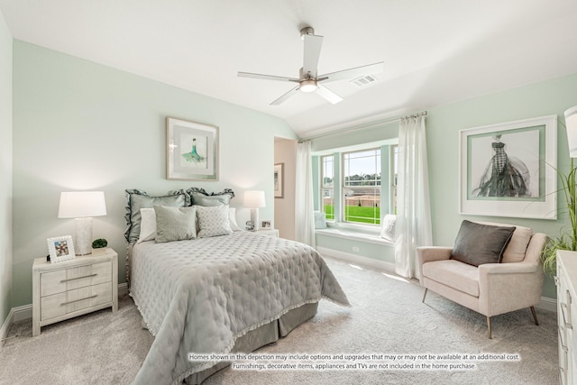 bedroom featuring light colored carpet, vaulted ceiling, and ceiling fan