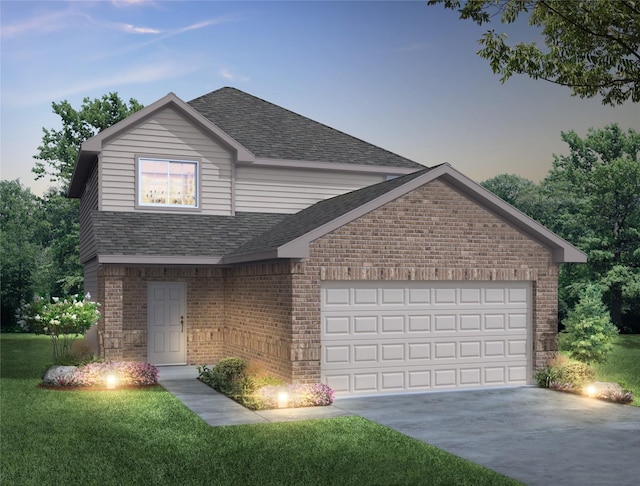 front facade featuring a garage and a yard