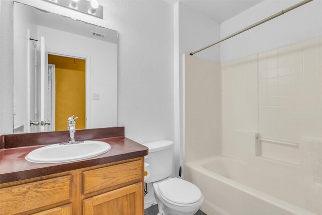 full bathroom with shower / tub combination, vanity, and toilet