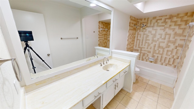 full bathroom featuring toilet, vanity, tile patterned floors, and tiled shower / bath