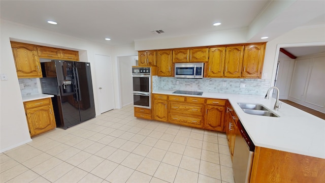 kitchen featuring backsplash, sink, light tile patterned floors, and black appliances