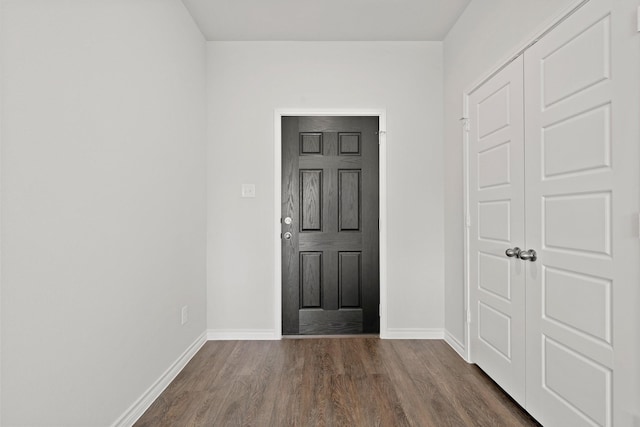 entrance foyer featuring dark wood-style floors and baseboards