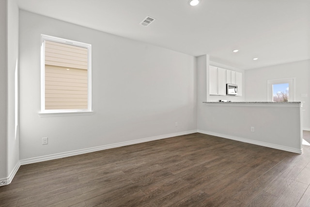 spare room featuring dark wood-type flooring