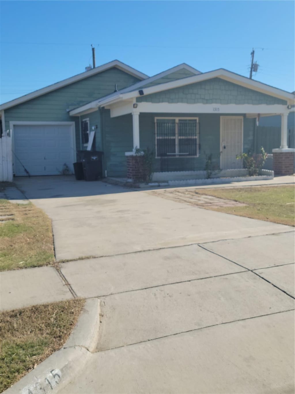 ranch-style house with a garage and covered porch