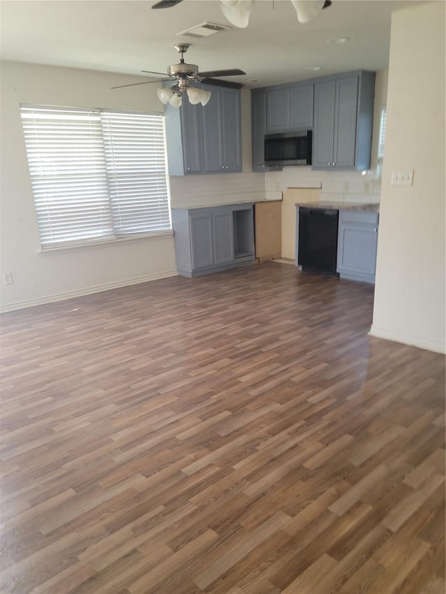 kitchen featuring gray cabinetry, ceiling fan, and dark hardwood / wood-style flooring