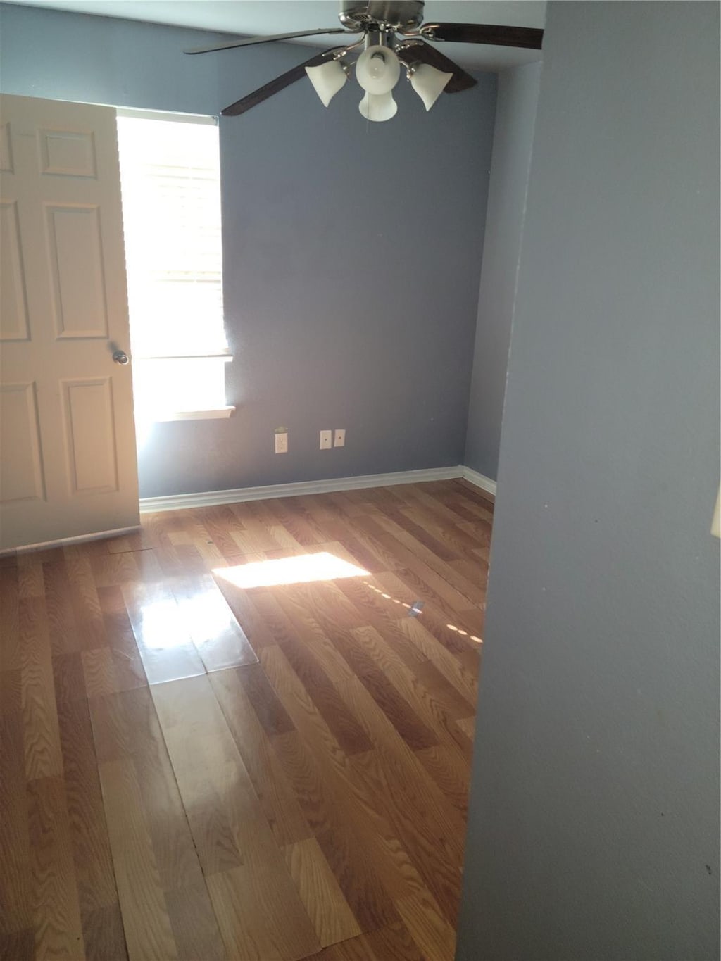 spare room featuring hardwood / wood-style floors and ceiling fan