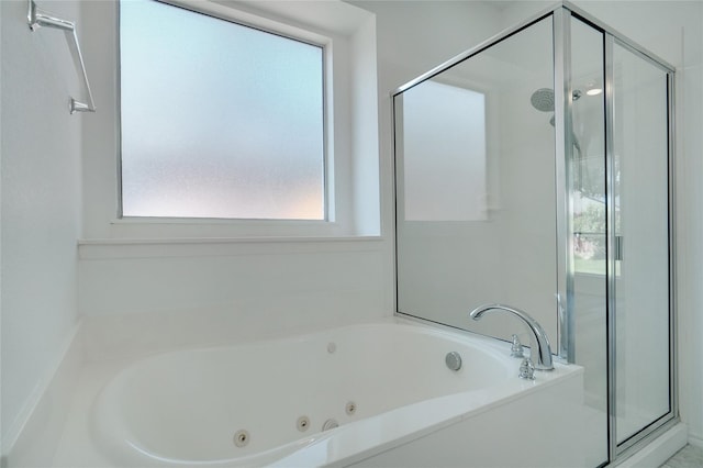 bathroom featuring shower with separate bathtub