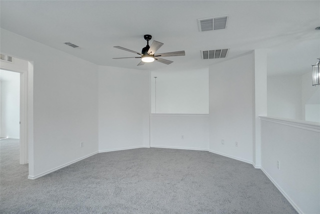 carpeted spare room featuring ceiling fan