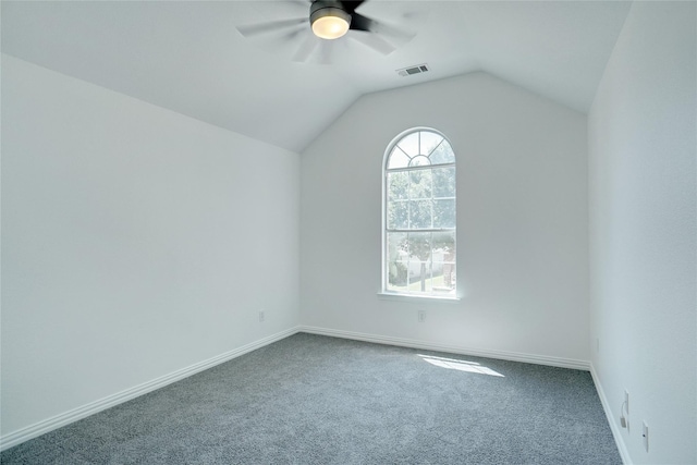 carpeted empty room with vaulted ceiling and ceiling fan