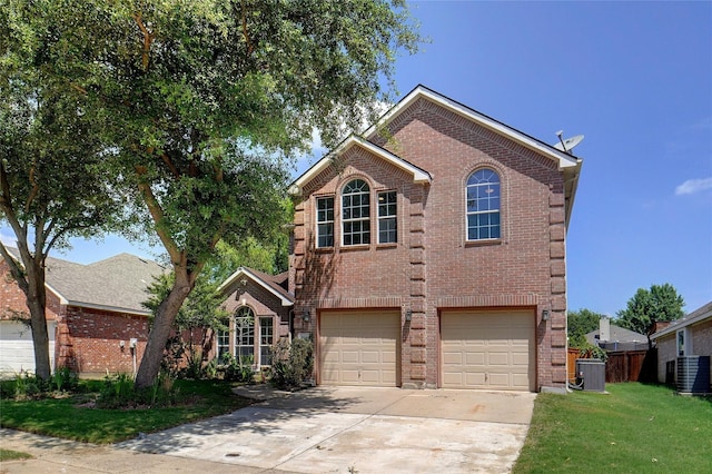 front facade featuring a front lawn, central AC unit, and a garage