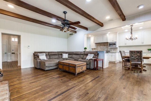 living room with beam ceiling, ceiling fan with notable chandelier, and dark hardwood / wood-style floors