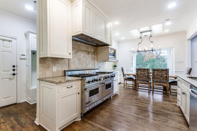 kitchen featuring light stone countertops, stainless steel appliances, crown molding, dark hardwood / wood-style floors, and hanging light fixtures