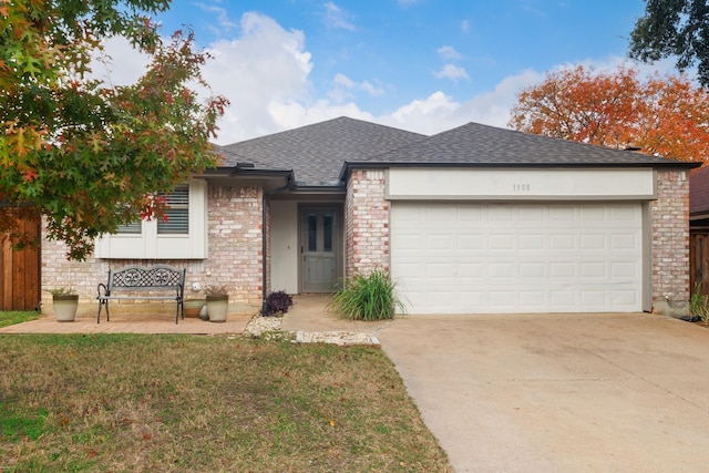 view of front facade with a front yard and a garage