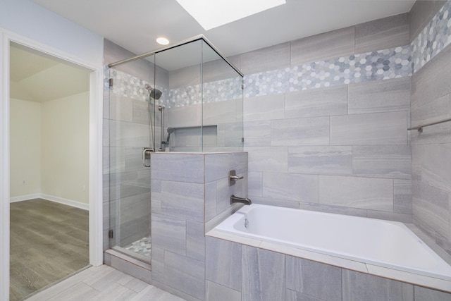 bathroom featuring hardwood / wood-style flooring and separate shower and tub