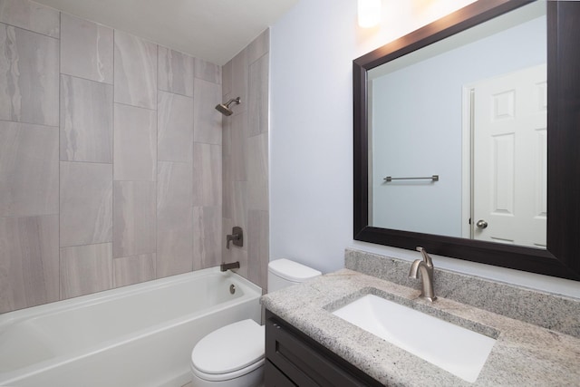 full bathroom with vanity, tiled shower / bath combo, and toilet