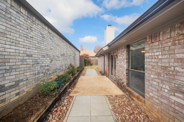 property exterior at dusk with a patio area