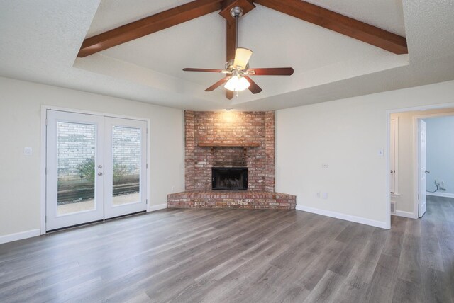 unfurnished living room featuring a textured ceiling, dark hardwood / wood-style floors, ceiling fan, and a fireplace