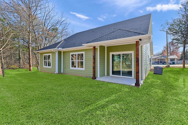 rear view of house with a patio area and a lawn