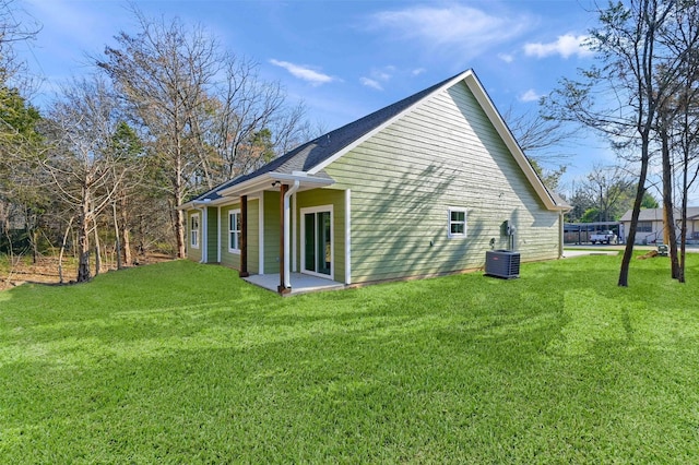 view of home's exterior featuring a patio, a yard, and central AC