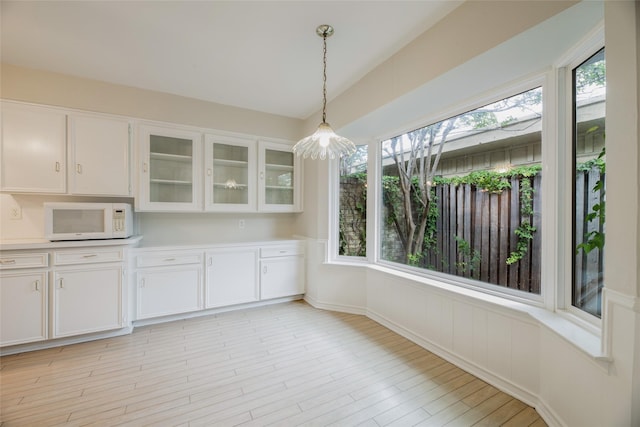 unfurnished dining area featuring plenty of natural light and light wood-type flooring