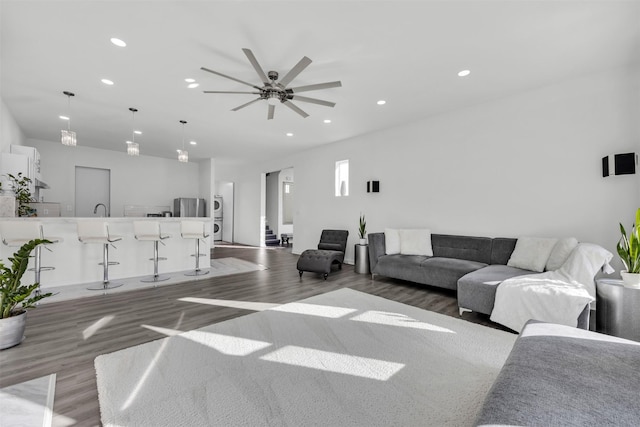 living room featuring ceiling fan and dark hardwood / wood-style floors