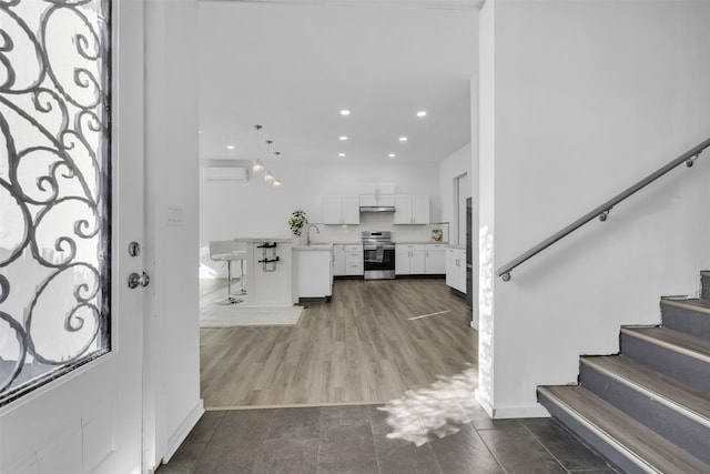 entryway with sink, dark hardwood / wood-style floors, and a wall mounted AC