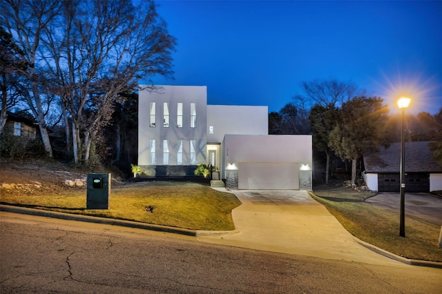 view of front of house featuring a garage and a yard