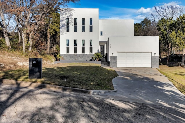 view of front of home with a garage and a front yard