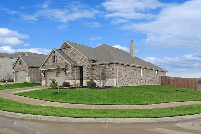 view of side of property with a lawn and a garage