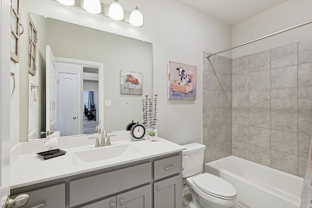 full bathroom featuring vanity, toilet, and tiled shower / bath