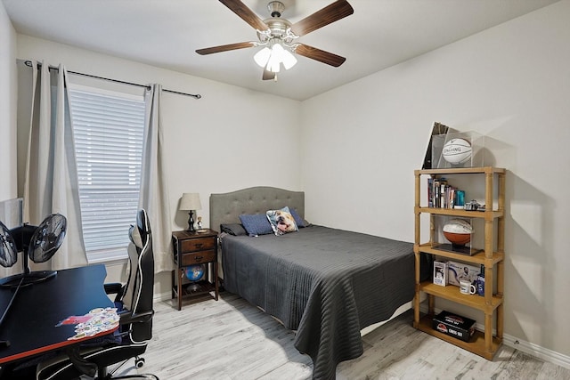 bedroom with ceiling fan and light hardwood / wood-style flooring