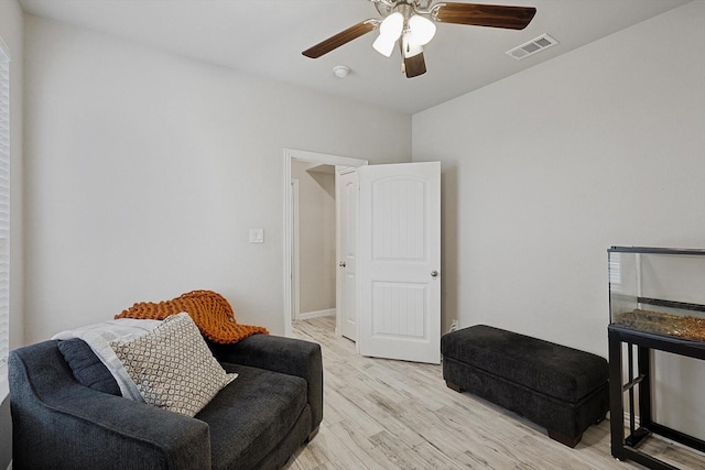 sitting room with light hardwood / wood-style flooring and ceiling fan