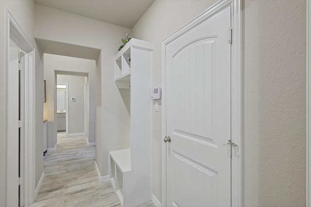 mudroom with light hardwood / wood-style flooring