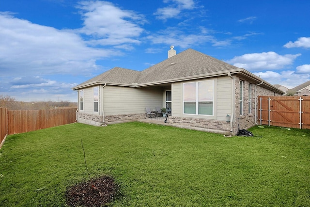 back of property featuring a patio and a lawn