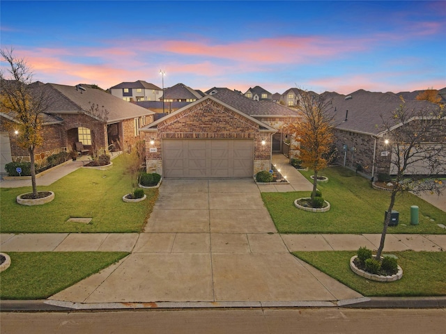 view of front facade with a front lawn, driveway, an attached garage, and brick siding