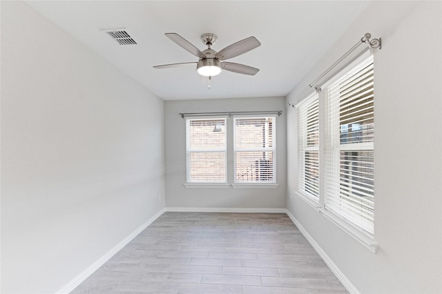 empty room featuring ceiling fan and light hardwood / wood-style flooring