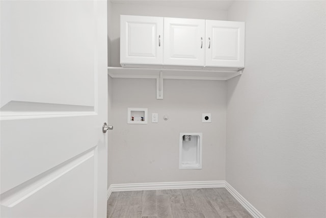 washroom with cabinets, washer hookup, light wood-type flooring, hookup for an electric dryer, and hookup for a gas dryer