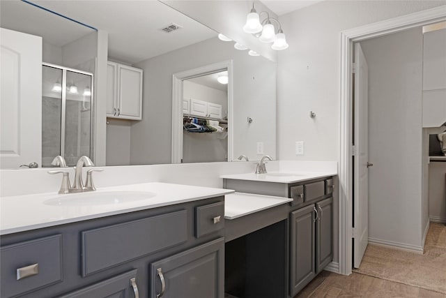 bathroom featuring walk in shower and vanity