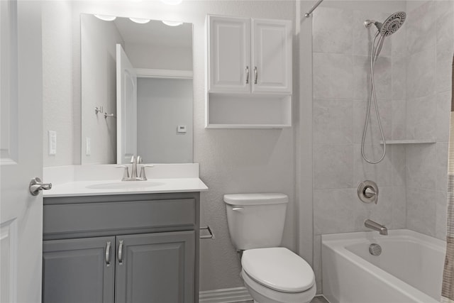 full bathroom featuring vanity, toilet, and tiled shower / bath