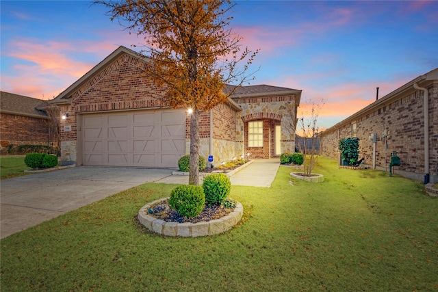 view of front of property featuring a garage and a lawn