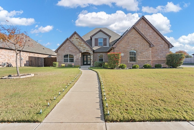 view of front of property featuring french doors and a front lawn