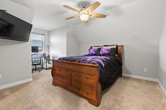 carpeted bedroom with ceiling fan and vaulted ceiling