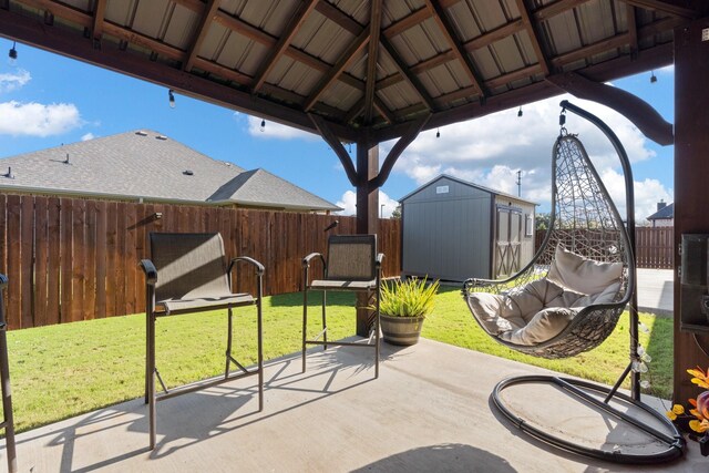 view of patio with a gazebo and a shed