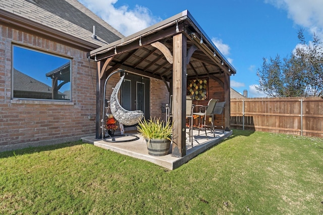 exterior space featuring a gazebo, a patio area, and a lawn