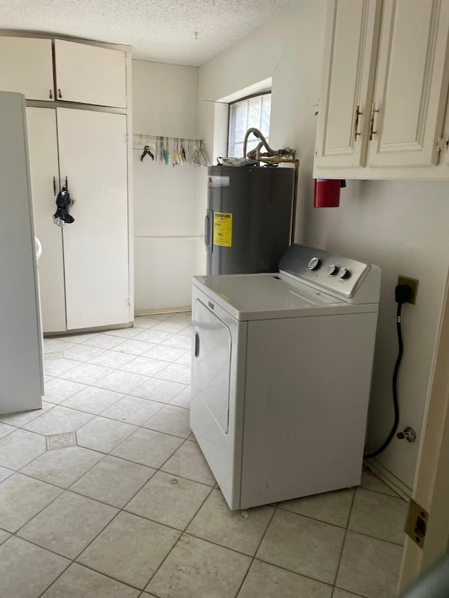 clothes washing area featuring cabinets, electric water heater, light tile patterned floors, a textured ceiling, and washer / clothes dryer